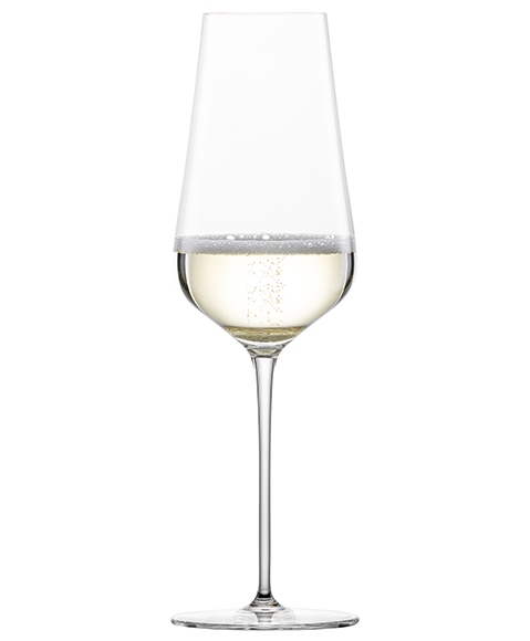 Verre à champagne Duo de Zwiesel Glas, rempli de champagne pétillant, sur fond blanc.